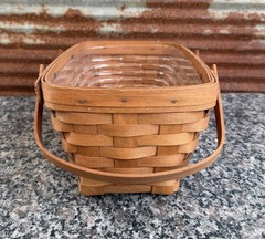 vintage 1993 Longaberger hand-woven handled basket with a clear plastic liner