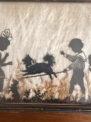 Vintage Milkweed Silhouette In Frame Depicting Children Playing With Dog