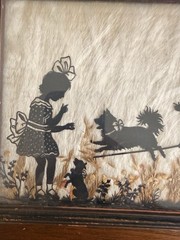Vintage Milkweed Silhouette In Frame Depicting Children Playing With Dog