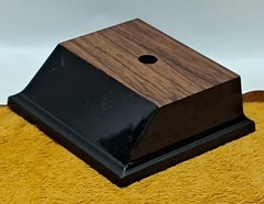 Trophy base, black plastic, woodgrain top, 3 7/6″W x 3 1/8″L x 1 1/4″H, #F.P.35