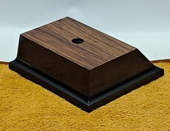 Trophy base, black plastic, woodgrain top, 3 7/6″W x 3 1/8″L x 1 1/4″H, #F.P.35