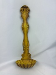 Vintage cast metal ladle-shaped wall hanging with ornate handle and scalloped