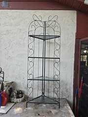 Vintage 6′ Metal corner baker’s rack with scrollwork design and glass shelves