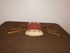 VINTAGE 20″ WIDE 12″ HIGH SEXTON METAL DRUM & SWORDS WALL HANG PLAQUE