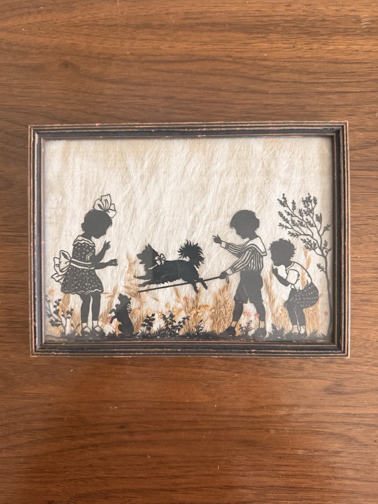 Vintage Milkweed Silhouette In Frame Depicting Children Playing With Dog