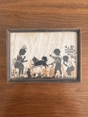 Vintage Milkweed Silhouette In Frame Depicting Children Playing With Dog
