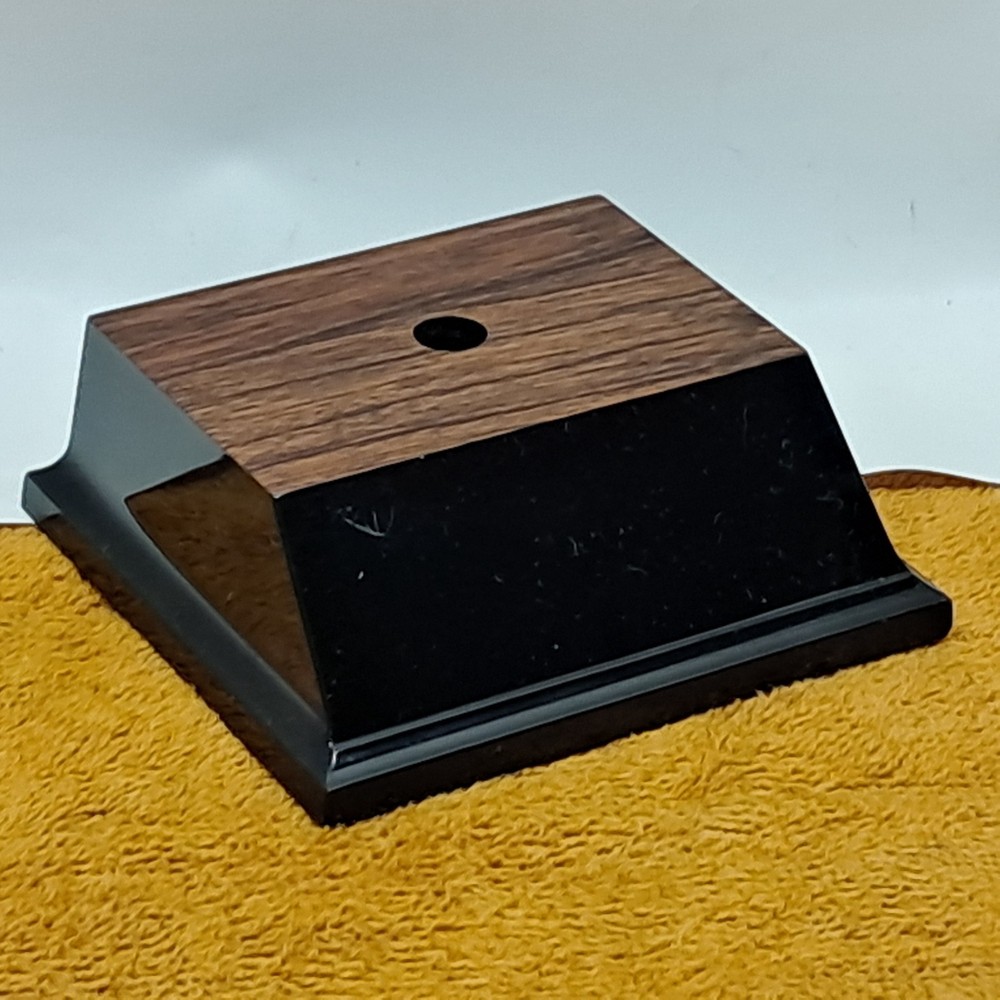 Trophy base, black plastic, woodgrain top, 3 7/6″W x 3 1/8″L x 1 1/4″H, #F.P.35