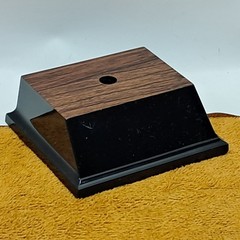 Trophy base, black plastic, woodgrain top, 3 7/6″W x 3 1/8″L x 1 1/4″H, #F.P.35