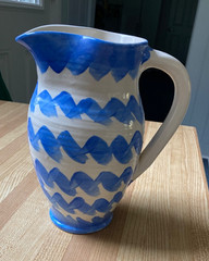 decorative ceramic pitcher. Blue/white zigzag pattern. 8.5″ tall. signed