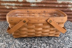 vintage 1993 Longaberger hand-woven handled basket with a clear plastic liner